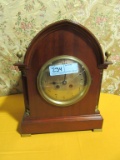 WOOD WITH BRASS ACCENTS MANTLE CLOCK. FACE GLASS CRACKED