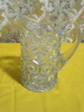 GLASS PITCHER. HAS CHIPS ON BOTTOM