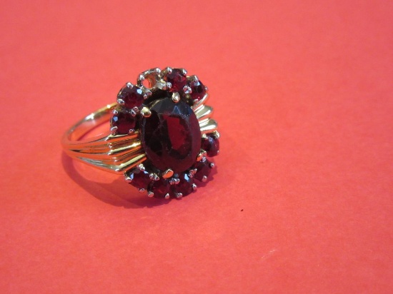 UNSTAMPED YELLOW GOLD SYNTHETIC RED STONE RING. ONE MISSING STONE