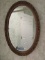 GOLD COLORED FRAMED OVAL WALL MIRROR