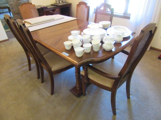 DINING ROOM TABLE WITH 1 LEAF AND 6 WOVEN BACK CHAIRS. 2 ARE HOST.