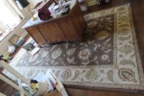 BROWN AND BEIGE FLORAL AREA RUG. MEASURING 8 BY 11.