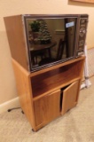 MINUTE MASTER MICROWAVE WITH OAK FINISH STAND IN BASEMENT
