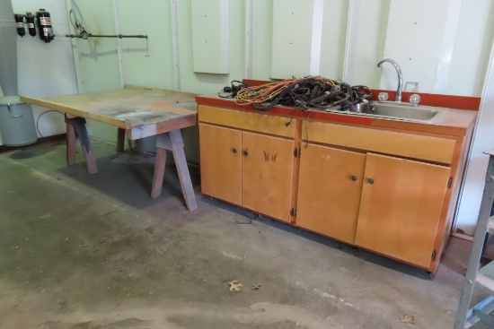 KITCHEN CABINET WITH SINK AND SAW HORSES WITH WOODEN RAMP