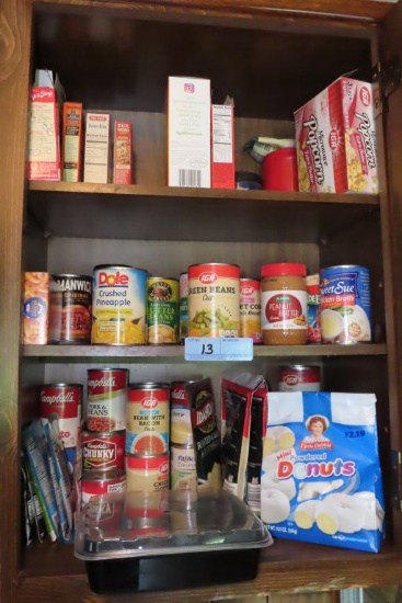CANNED GOODS AND ETC IN CABINET. SOME ITEMS ARE OPENED. SOME OUTDATED