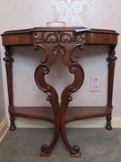 CARVED MAHOGANY STAND. ON SECOND FLOOR. 28" WIDE. 26" TALL. 13" DEEP.