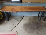 rough cut, rustic style wooden and metal bench. approximately 53-1/4 in long by 12-3/4 in wide at