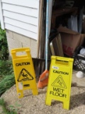 folding plastic wet floor signs with shovel and broom.