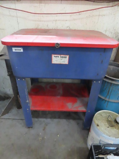 blue and red parts washer. has solvent in it. buyer must drain unit and take solvent with them.