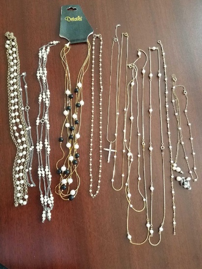 costume jewelry necklaces, pearl like stones on silver and gold colored necklaces, and two pairs of