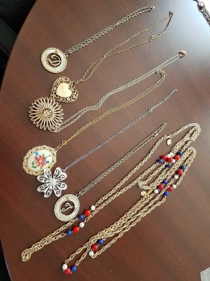 gold colored costume jewelry necklaces with decorative pendants