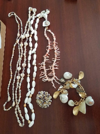 shell necklaces, bracelet, and pin