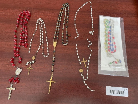5 assorted rosaries. 3 are broken.