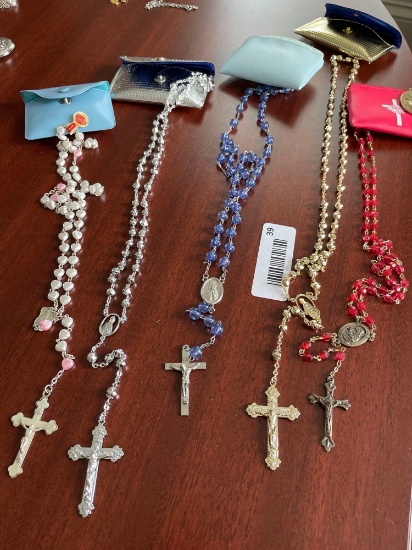5 assorted rosaries with cases.