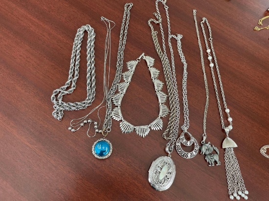 8 silver colored necklaces.