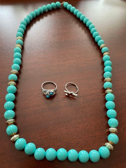 Turquoise like necklace and ring and silver colored ring.