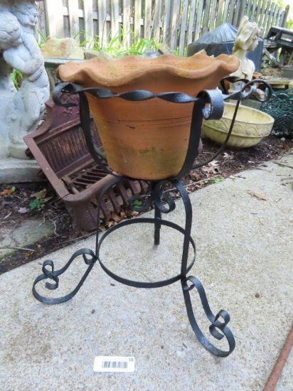 wrought iron plant stand with clay planter