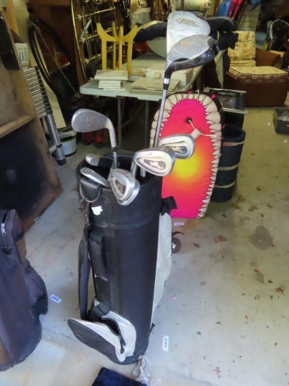 variety of golf clubs with black golf bag