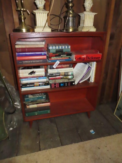 wooden bookshelf with variety of books on third floor