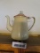 cream with red rim granite ware teapot with glass handle