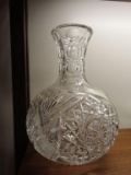 heavy cut glass decanter/vase. has chips on bottom.