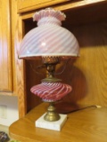 cranberry and white frosted glass electrified oil lamp on marble base