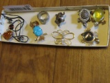 variety of pins, spoon ring, glass heart necklace