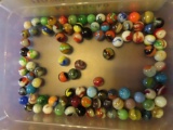 plastic bin of various marbles