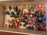 cigar box with various marbles