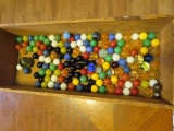 vintage wooden box with various marbles