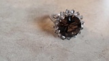 large brown gemstone ring surrounded by clear gemstones, marked 925