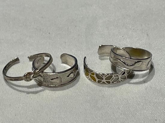 Set of four sterling silver toe rings.