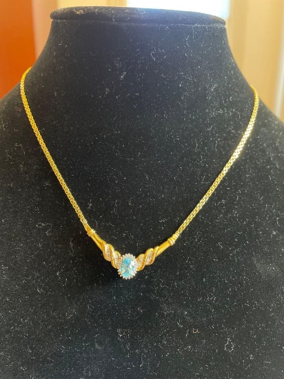 Gold plated sterling necklace with clear and blue stones.