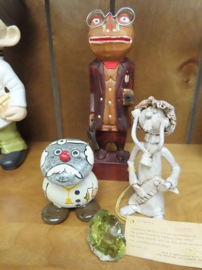 Variety of doctor figurines and green stone