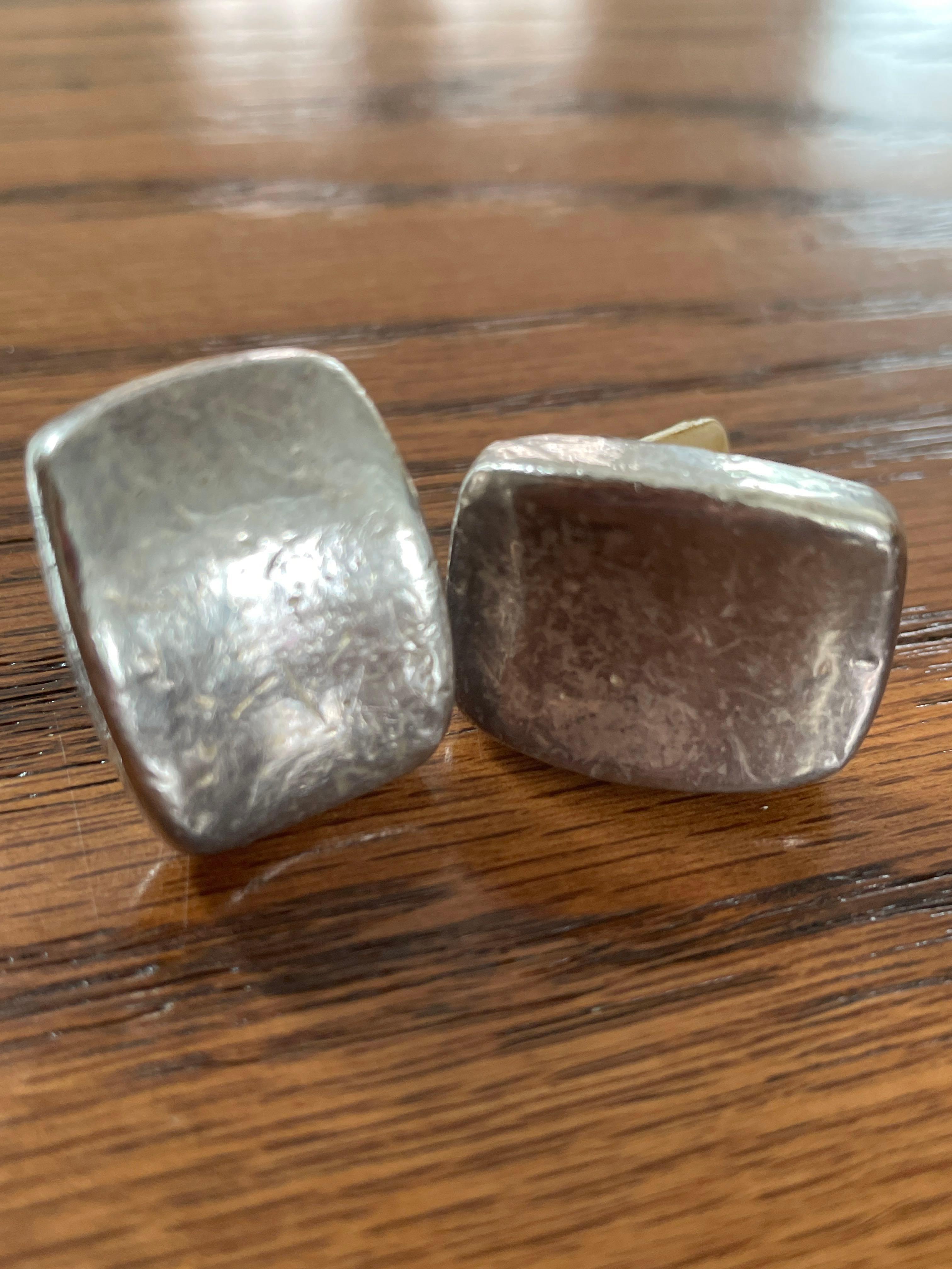 Silver colored clip on earrings. Marked SSD 925.