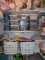 Three shelves of crafting items including beads. flowers. fasteners. ribbon.