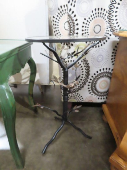 Metal stand with bird figurine and glass top