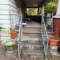 Contents of front porch including redwood porch furniture, planters, extension cord, crock. Must
