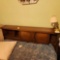Vintage bedroom suite including full size bed, dresser with mirror, chest of drawers, and two