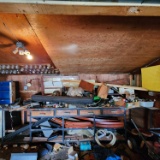 Approximately 12 ft metal framed workbench and contents.