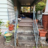 Contents of front porch including redwood porch furniture, planters, extension cord, crock. Must