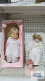 Two porcelain dolls and one porcelain doll upper body
