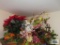 Lot of florals, metal candle holder, bird decoration and etc on top of cabinet