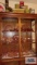 Lot of assorted pink glassware inside cabinet including some depression glass