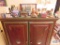 Lot of figurines, wooden houses, brass decorative lamp, mugs and etc on top of cabinet