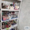 Lot of VHS tapes, candles and etc on shelving