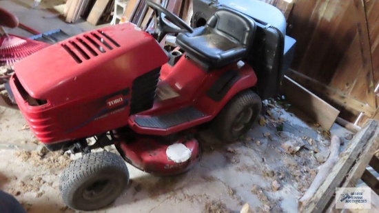 Toro wheel-horse riding mower with bagger attachment and 14.5 hp engine. Headlight assembly is