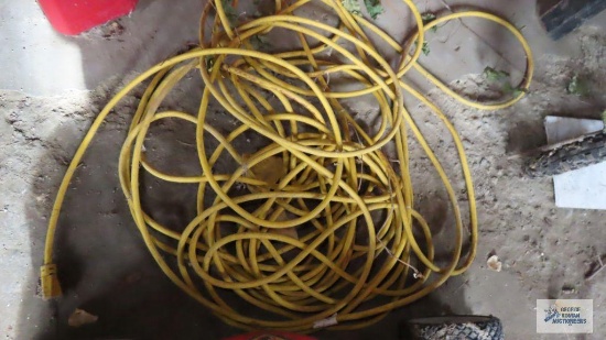 Heavy duty yellow extension cord with three outlet end