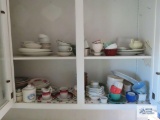 Lot of plates, cups, creamers, sugars and etc in two-door cabinet