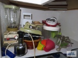 Blender, graters, plastic ware, etc on shelf